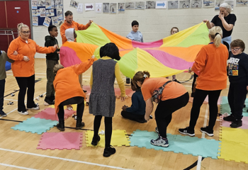 children playing with parachute