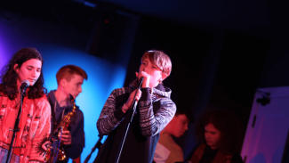 Image of children performing and singing on stage