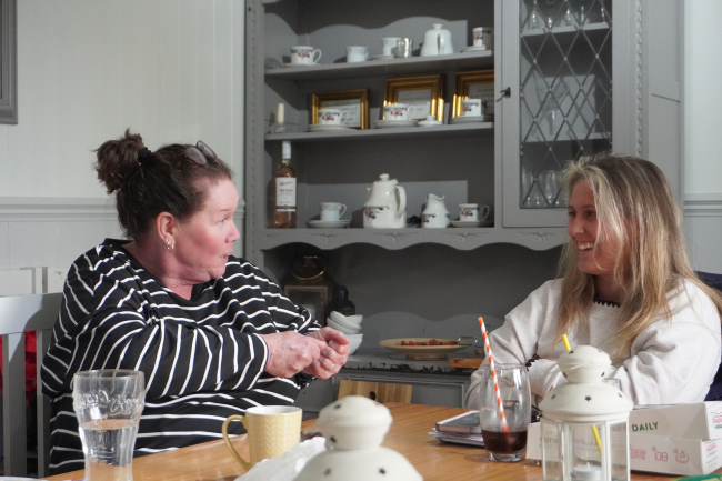 two adults having coffee and a chat